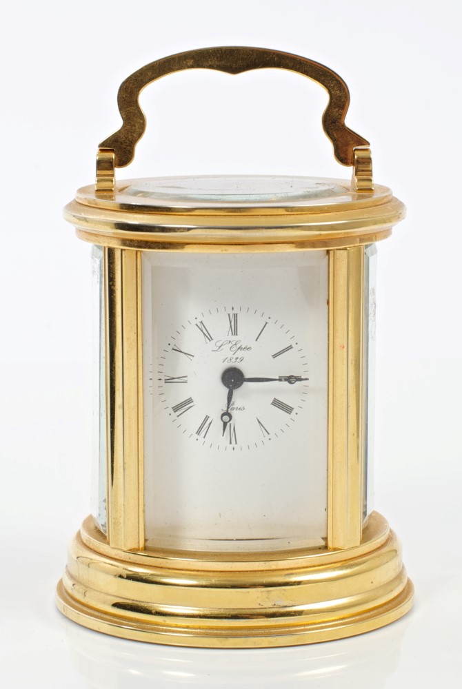 Contemporary gilt brass carriage clock in oval-form case, with white enamel dial,