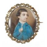 18th century oval portrait miniature on ivory of a young man wearing a blue overcoat,