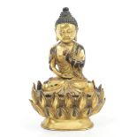 Tibetan gilt brass Buddha in mediative pose, on lotus flower plinth with solid base,
