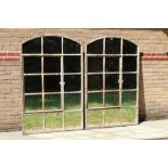 Pair of arched mirrored panels, each with fifteen square plates with steel frame,
