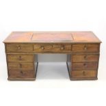 Victorian mahogany desk, the tooled leather inset top with rachetted slope,