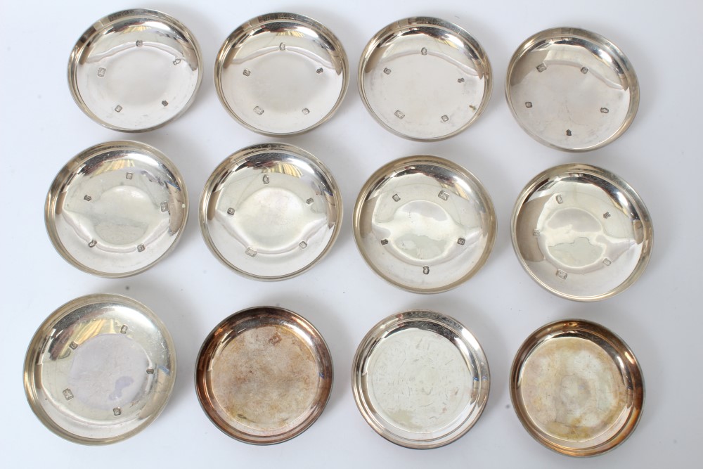 Set of nine contemporary silver dishes of circular form,