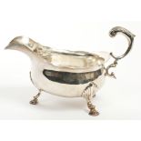 Pair late George II silver sauce boat of conventional form, with wavy rim and open scroll handle,