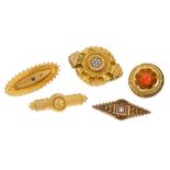 Collection of five Victorian gold brooches - to include an Etruscan revival target brooch with