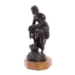Antique Continental bronze figure of a semi-clad female bather, on rocky outcrop base,