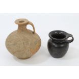 Roman red terracotta bulbous bottle with loop handle and wide collar, raised on circular foot,