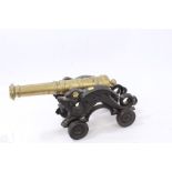 Decorative 19th century brass model cannon on cast iron dragon decorated carriage,