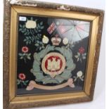 First World War era Suffolk Regiment embroidered panel with regimental badge amongst flowers,