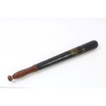 Victorian turned wood truncheon with ribbed grip and tapered shaft, with black painted finish,