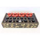 Lacquered games box with chinoiserie decoration containing draughts