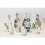 Collection of nine Lladro porcelain figures - including boy with boat, 'Musically Inclined',