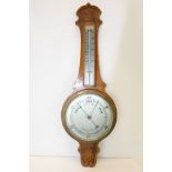 Aneroid barometer / thermometer in carved oak case