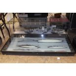 Large model Naval ship in display cabinet and other battleships in a wall hanging display cabinet