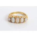 Gold (18ct) five stone opal ring interspaced with eight diamonds in scroll setting.