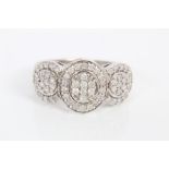 White gold (9ct) diamond cluster ring with circular diamond set plaques in white gold setting.