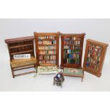 Dolls' house items - including bookcases with books, painted chest of drawers, tables,