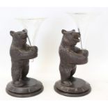 Pair carved Black Forest bears on circular bases, each holding a glass trumpet vase,