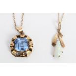 Yellow metal pendant set with a central square cut blue stone, indistinctly marked,