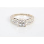 Diamond ring with a square cluster of four princess cut diamonds,