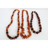 Two amber necklaces with polished spherical amber beads and natural free-form amber spacers and