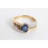 Two-colour gold (18ct) sapphire and diamond crossover ring with a central mixed cut oval sapphire