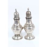 Pair Edwardian silver pepperettes of baluster form, with pierced slip-in covers,