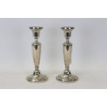 Pair filled sterling silver candlesticks with urn-shaped columns and bell-shaped candleholders,