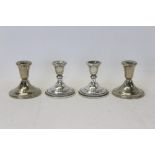 Pair filled sterling silver dwarf candlesticks with gadrooned borders and bell-shaped candleholders,