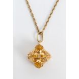 Yellow metal pendant set with four oval mixed cut citrines on gold (9ct) chain CONDITION