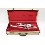 Armand et Cie silvered trumpet with engraved foliate decoration, mouthpiece and mute,