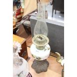Two Victorian glass oil lamps with floral decoration and cast iron bases and one other (3)