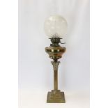 Late 19th / early 20th century oil lamp with brass reservoir and etched globe shade and separate