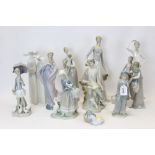 Collection of eleven Lladro and Nao porcelain figures - including lady holding flowers,