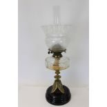 Early 20th century brass oil lamp with etched glass shade and faceted clear glass reservoir,