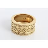 Gold (18ct) thick band ring with geometric decoration.