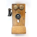 Early 20th century wall mounted telephone with separate speaker and earpiece,