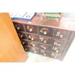 19th century bank of painted pine pharmacy drawers with four rows of five numbered drawers,