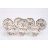 Five 18th century Lowestoft polychrome tea bowls and saucers with painted floral sprays and ribbon