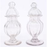 Pair 18th century fluted glass jars and covers, raised on moulded splayed foot,