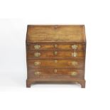 George III oak bureau with fitted interior of short drawers and pigeon holes and four long