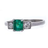 Art Deco emerald and diamond three stone ring with a central step cut emerald flanked by two old