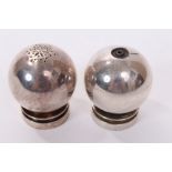 Harald Nielsen for Georg Jensen, pair of spherical salt and pepper pots on stepped circular bases,