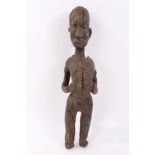 Unusual antique African carved wooden figure of a man wearing a mask necklace,