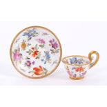 Early 19th century English porcelain miniature cup and saucer with finely painted floral decoration,