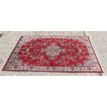 Indian part silk rug, aubergine ground with central stellar medallion in multiple meander borders,