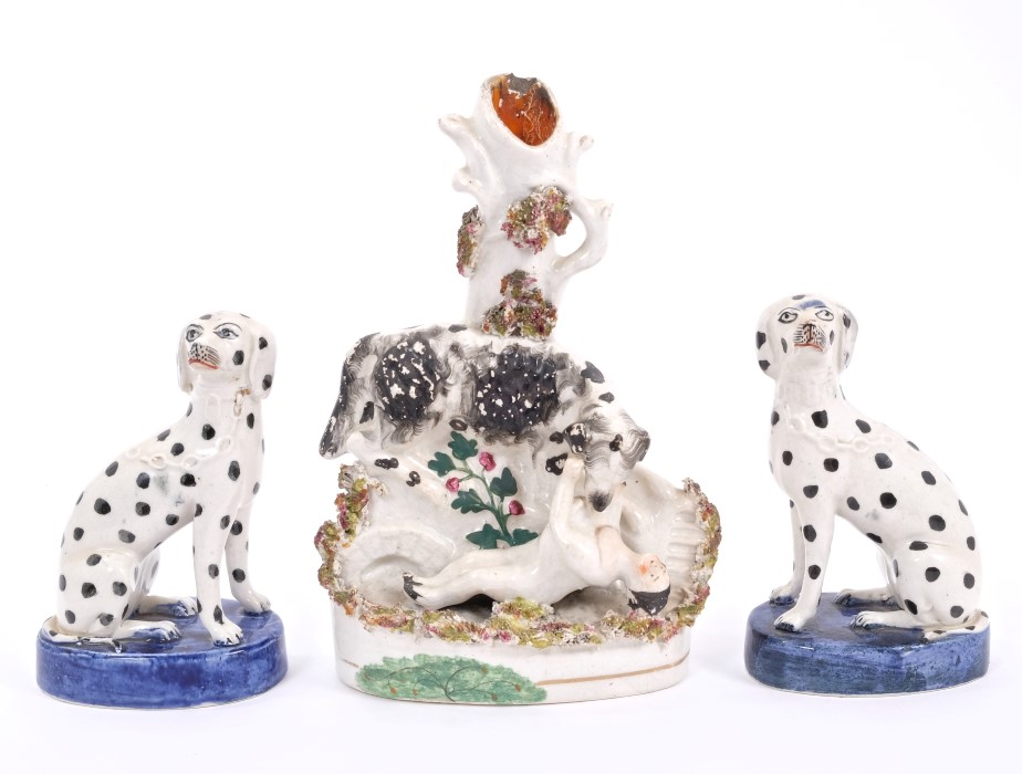 Pair 19th century Staffordshire figures of seated dalmatians, with blue oval bases,