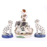 Pair 19th century Staffordshire figures of seated dalmatians, with blue oval bases,