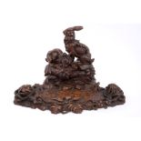 Large late 19th century Black Forest carved wood desk stand decorated with two rabbits,