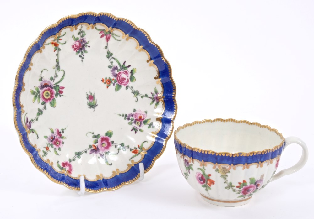 18th century Worcester polychrome fluted tea cup and saucer with painted floral swags and blue and