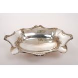 Edwardian silver bread dish of fluted oval form, with reeded and scroll border,